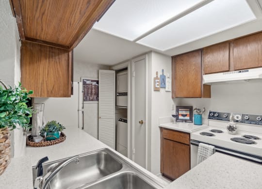 a kitchen with white countertops and a stainless steel sink at Pebblebrook, Kansas, 66212