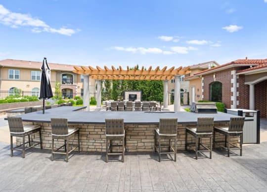 a large outdoor entertaining area with a bar and tables