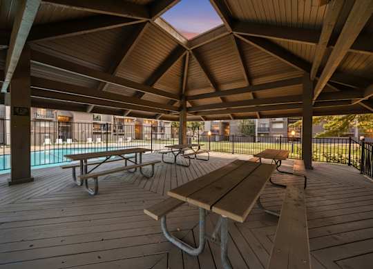 Wooden deck with picnic tables at Bremerton Park Apartment Homes , Prairie Village, KS