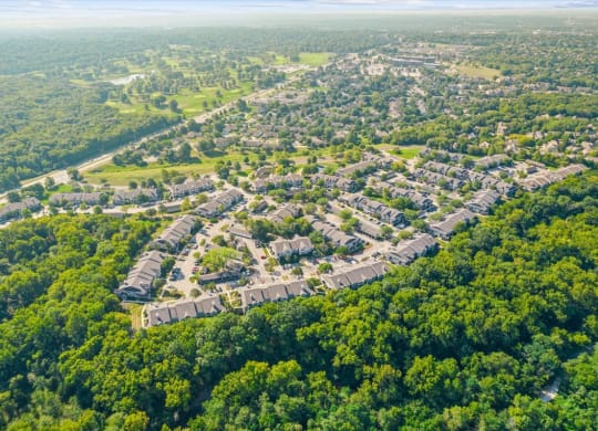 an aerial view of a neighborhood surrounded by treesat Stonebriar Woods Apartments, Overland Park, KS