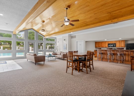 a large living room with a vaulted ceiling and large windowsat Millcreek Woods Apartments, Olathe, KS