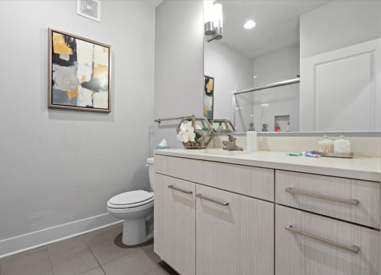 a white bathroom with a toilet and a sink