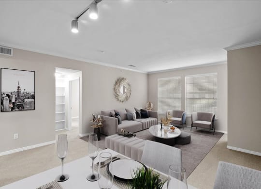 a living room with a grey couch and a white coffee table at The Clairborne Apartment Homes, Grand Prairie, Texas