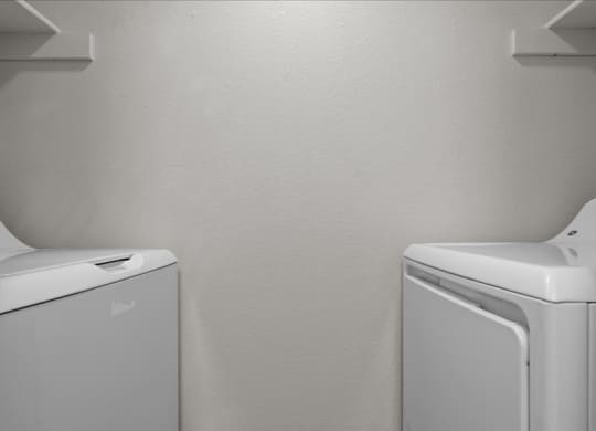 a white washer and dryer in a white room at Highland Park Apartment Homes, Kansas, 66214
