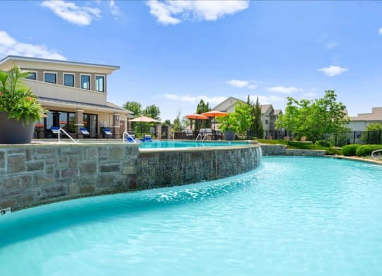 a large swimming pool with a building in the background
