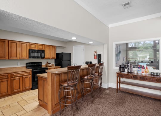 a kitchen with a large island and a breakfast bar at Millcreek Woods Apartments, Olathe, Kansas