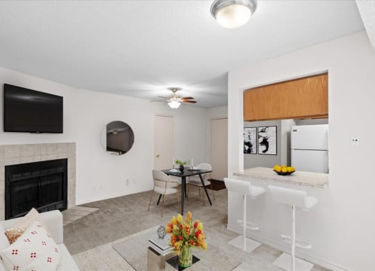 a living room with a kitchen and a dining room at Wind River Lodge, Lenexa, KS
