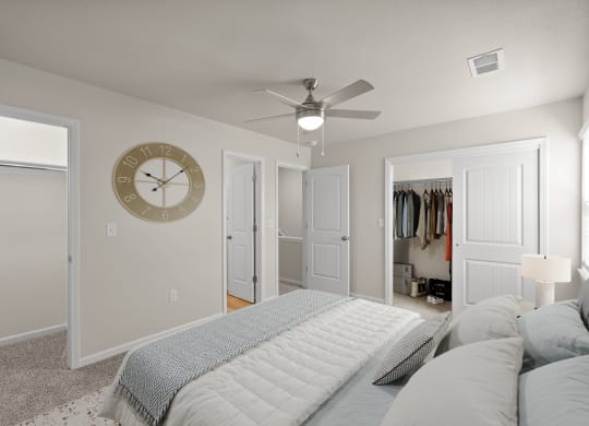 a bedroom with a large bed and a clock on the wall