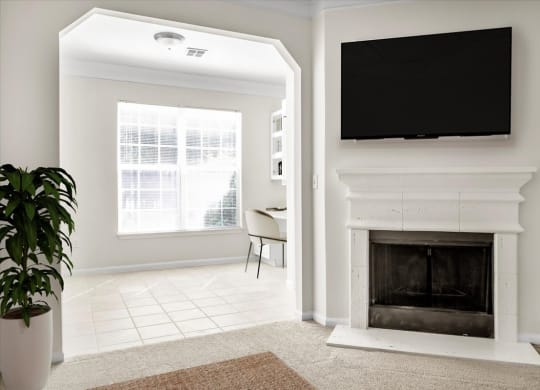 a living room with a fireplace and a tv above it