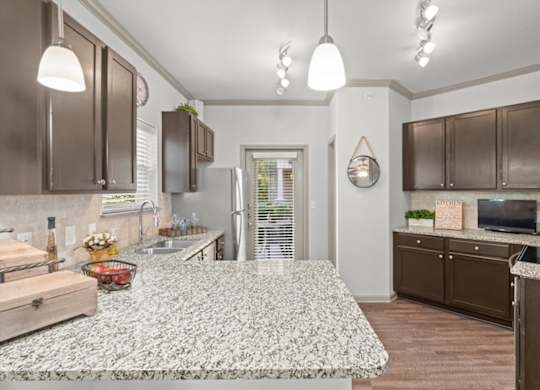 a kitchen with a large island in the middle of it at Stonepost Crossing Apartments, Overland Park, KS, 66213