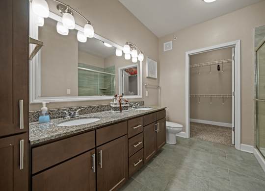 A bathroom with a sink, mirror, and toilet.