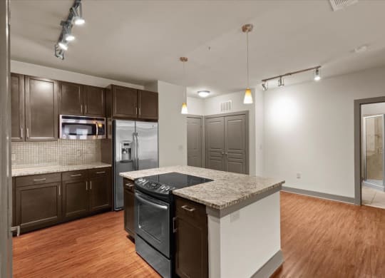 a kitchen with an island and a stove top oven