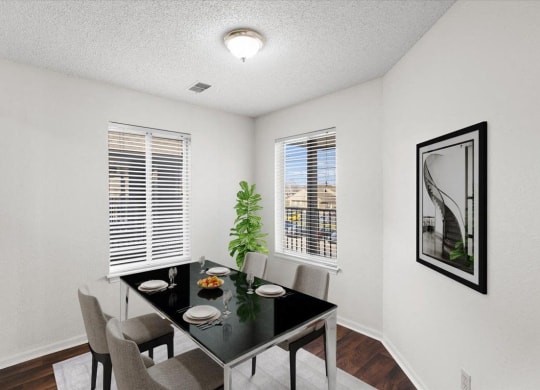 our apartments offer a dining room with a black table and chairs at Deerfield Apartments, Olathe, Kansas