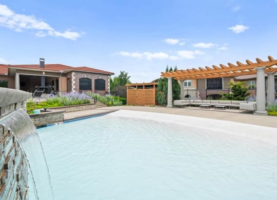 a large swimming pool in front of a house