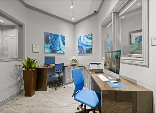 A modern office with a blue chair and a brown desk.