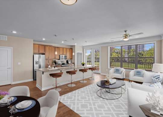 a living room and kitchen with a large window at The Dorset, Kansas City, MO