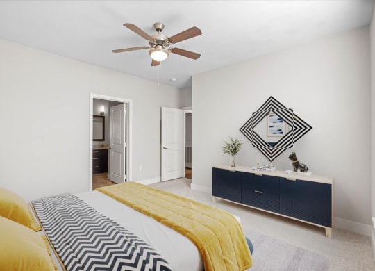 a bedroom with a bed and a ceiling fan