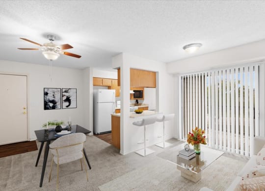 a living room with a kitchen and a ceiling fan at Wind River Lodge, Lenexa, 66219