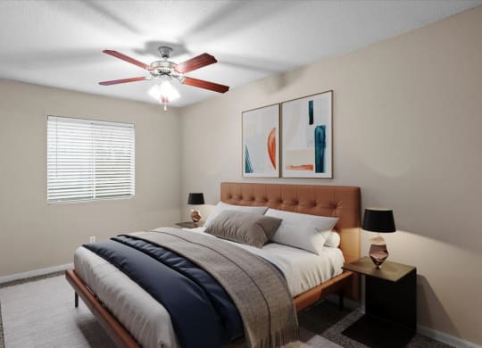 A bedroom with a ceiling fan and window.