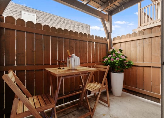 a small patio with a table and two chairs