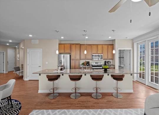 a kitchen and living room with a large island at The Dorset, Kansas City, 64112