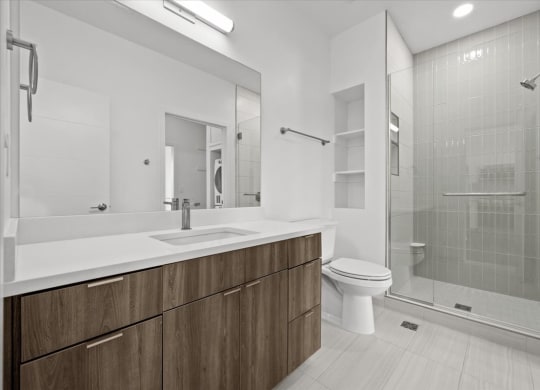 a bathroom with a toilet sink and a shower