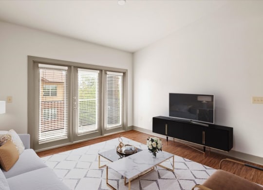 a living room with white walls and hardwood floors