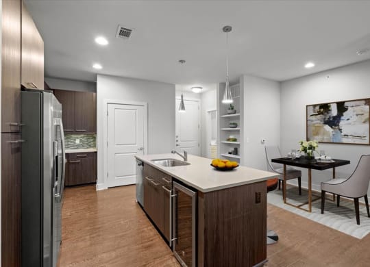 a kitchen and dining room with a table and a refrigerator