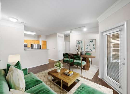 A living room with a green couch and a wooden coffee table. at Somerset Oaks Apartment Homes, Olathe, KS, 66062