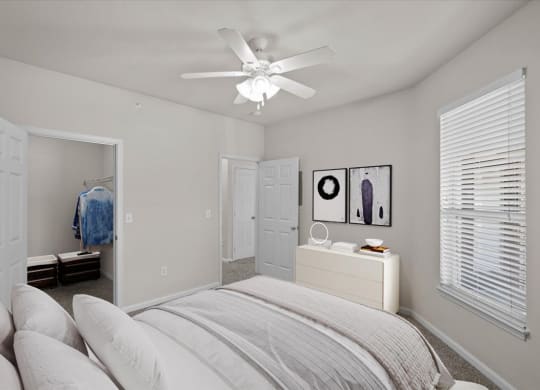 a bedroom with a bed and a ceiling lamp