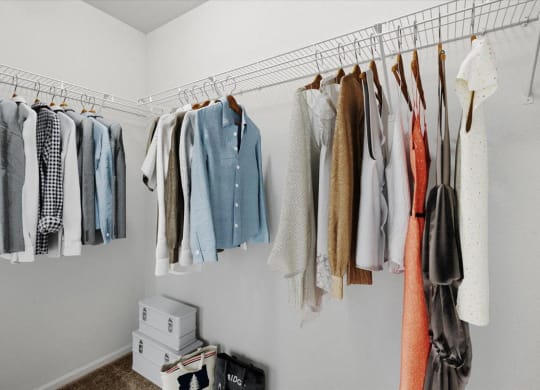 a closet with clothes hanging on a rack at Stonepost Lakeside, Olathe