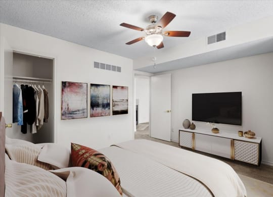 a bedroom with a bed and a ceiling fan at Wind River Lodge, Lenexa, Kansas