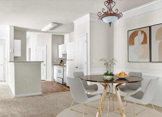 an open kitchen and dining room with a table and chairs