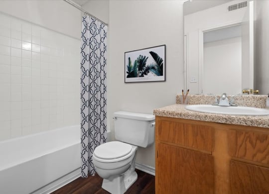 a bathroom with a sink toilet and bath tub at Wind River Lodge, Lenexa, KS
