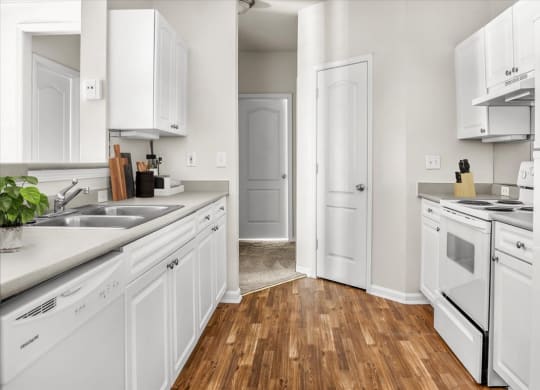 a kitchen with white cabinets and white appliances