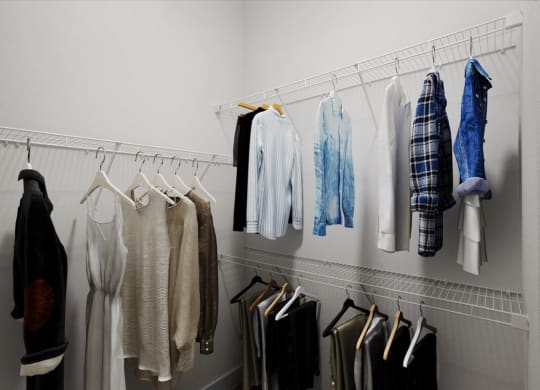 a rack of clothes hanging in a closet