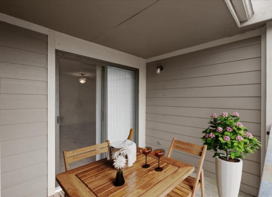 a patio with a wooden table and chairs and a sliding glass door at Wind River Lodge, Kansas