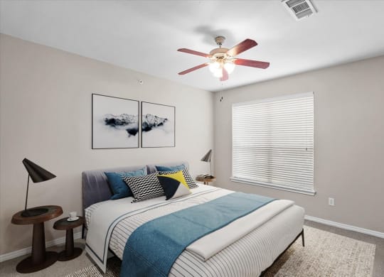 a bedroom with a bed and a ceiling fan at The Clairborne Apartment Homes, Grand Prairie, TX, 75050