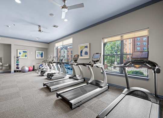 A gym with treadmills and exercise equipment.