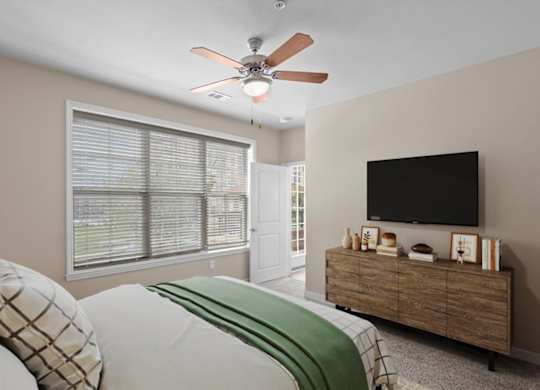 a bedroom with a large window and a ceiling fan at The Dorset, Kansas City, Missouri