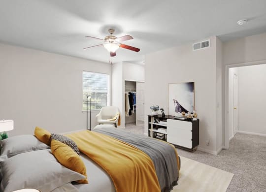 A large bedroom with a ceiling fan, a window and a bedroom closet.