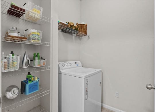 a white washer and dryer in a room with a closet at Stonepost Lakeside, Olathe, Kansas