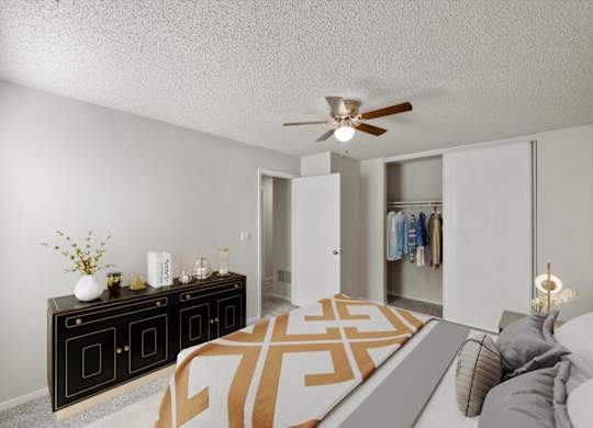 A living room with a black and white color scheme and a ceiling fan.