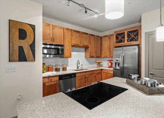 a kitchen with wooden cabinets and a granite counter top