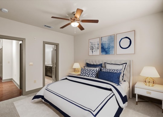 a bedroom with a large bed and a ceiling fan