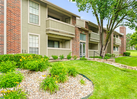 A building with a green lawn in front.