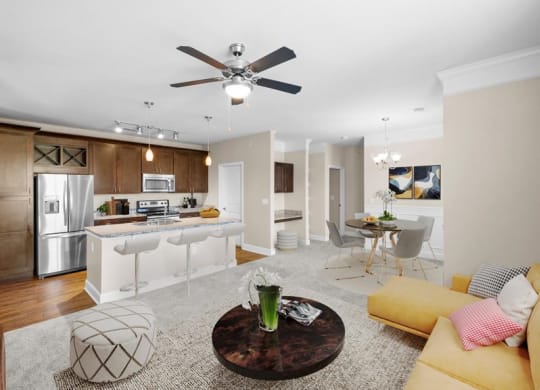 a living room and kitchen with a ceiling fan