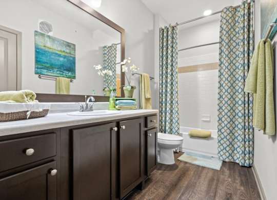 a bathroom with a sink toilet and shower at Stonepost Crossing Apartments, Overland Park, 66213