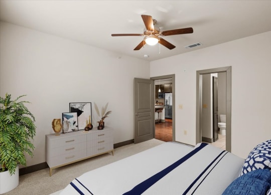 a bedroom with a bed and a ceiling fan