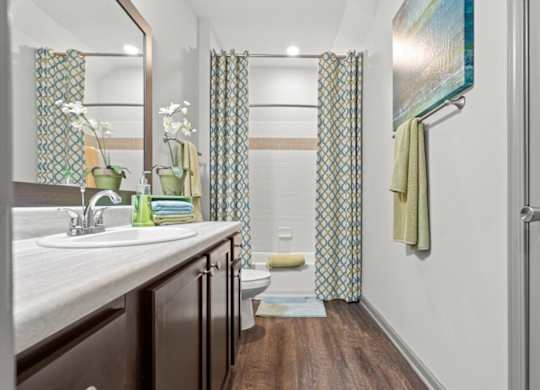 a bathroom with a toilet sink and shower at Stonepost Crossing Apartments, Kansas, 66213